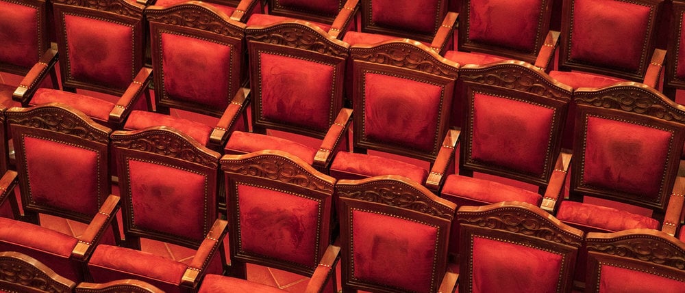 The seats are lined with soft red velvet cushions, creating a feeling of relaxation throughout the performance